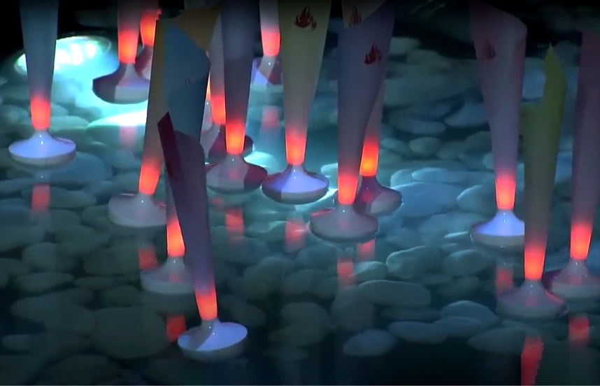 Tall, cone-shaped lanterns, illuminated by red electric lights, float in a pool of water above submerged white stones.